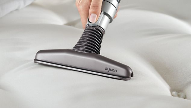 Matress tool being used to vacuum bed