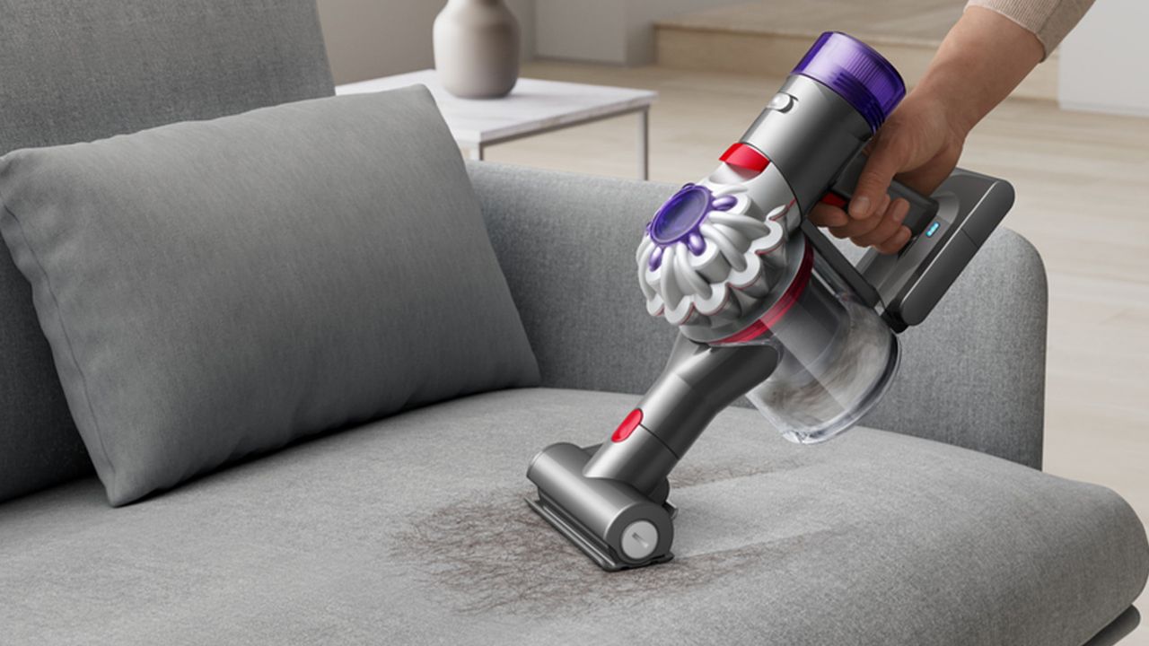 A Dyson Car+Boat vacuum cleaner is used with the Mini motorised head to deep clean their sofa cushions.
