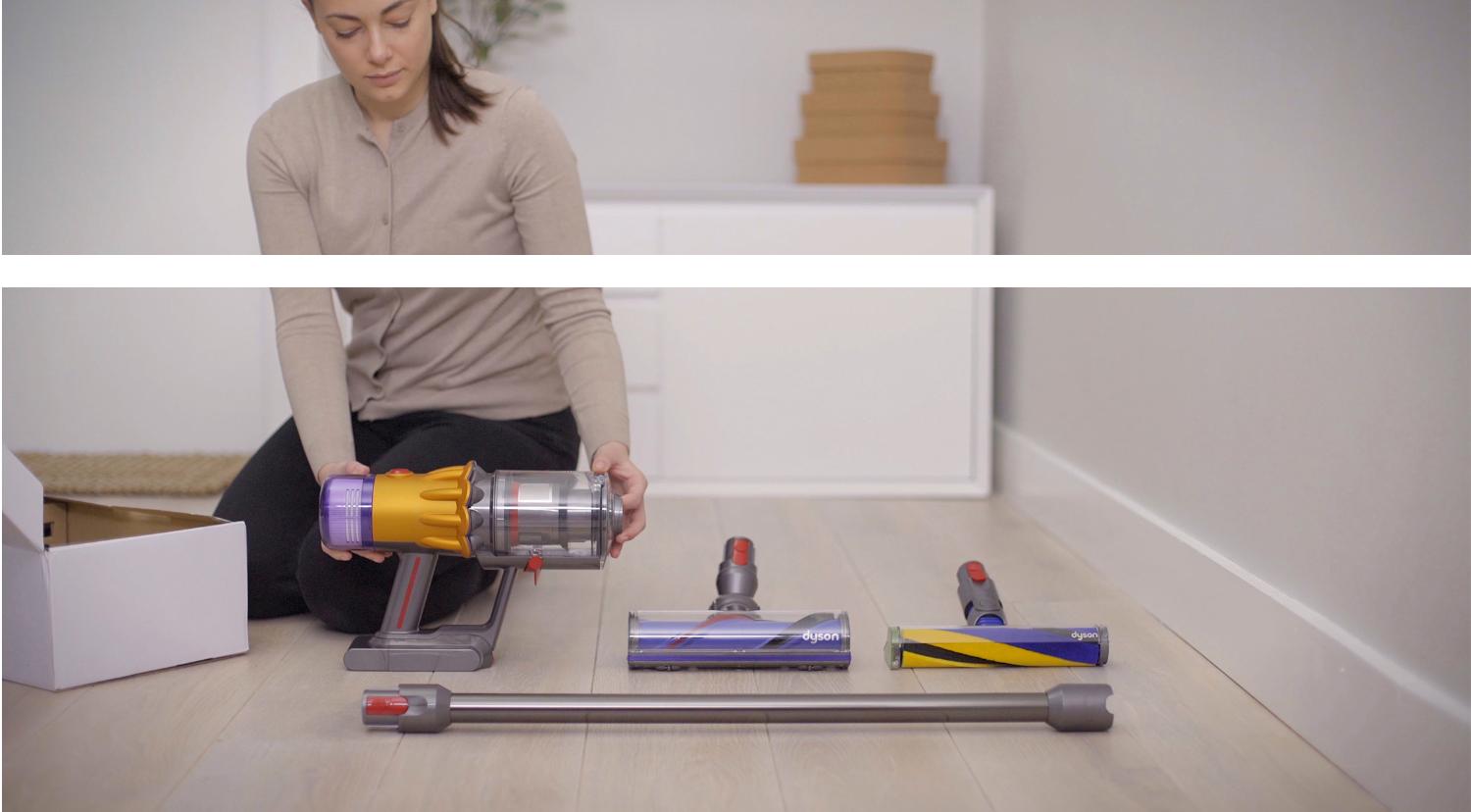 Someone holding the Dyson V12 Detect Slim vacuum while it's resting on the floor.