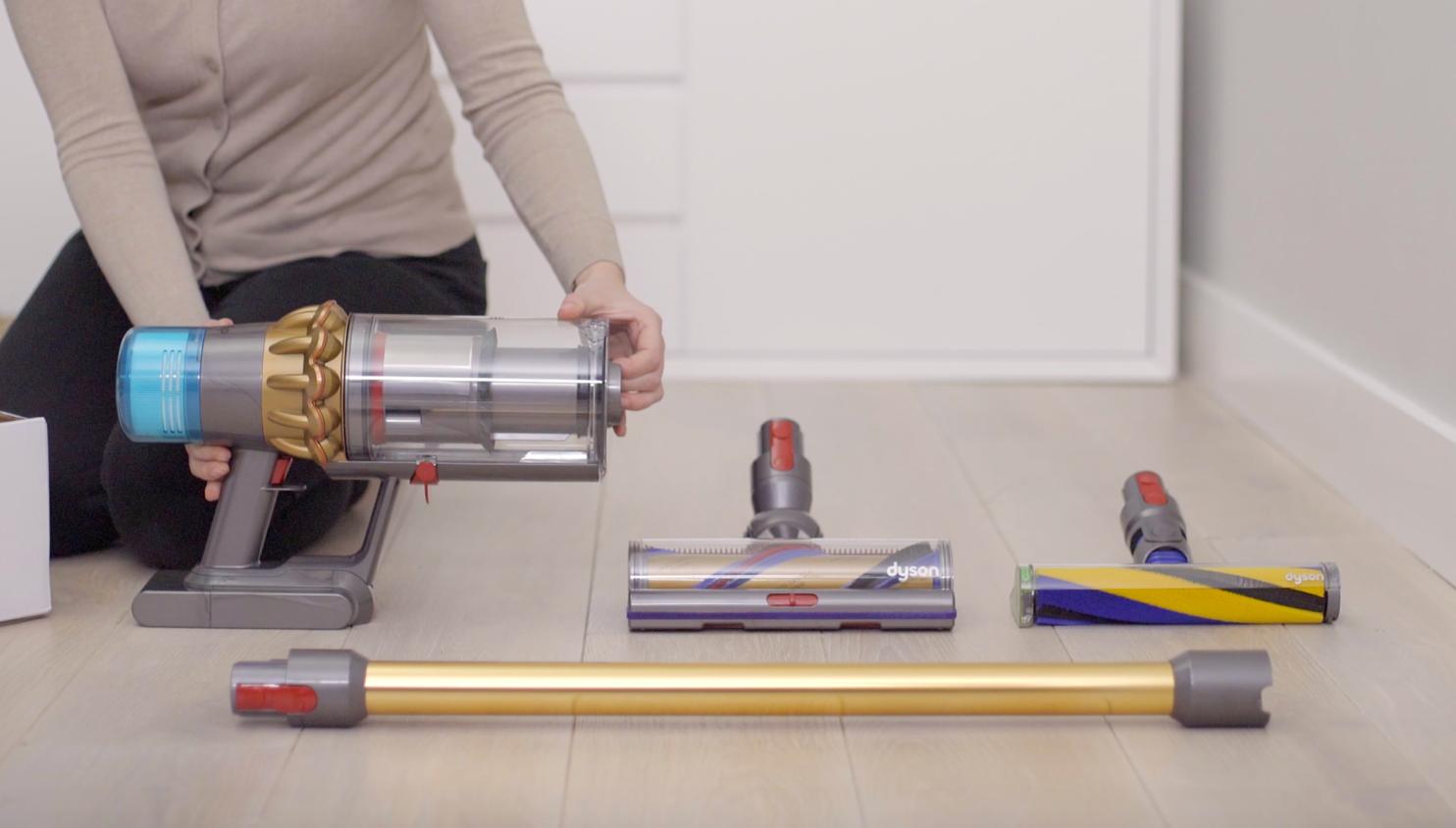 A vacuum cleaner being assembled.