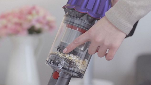 Dyson Digital Slim掃除機のクリアビンのMaxラインを指差す指