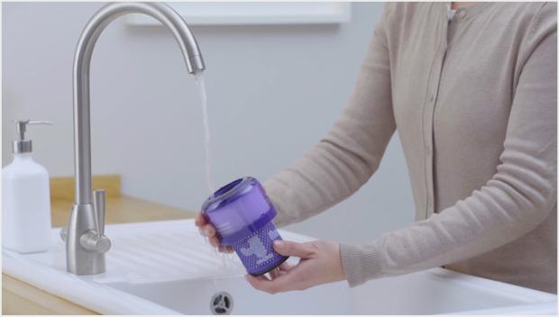 Filter being washed at the sink