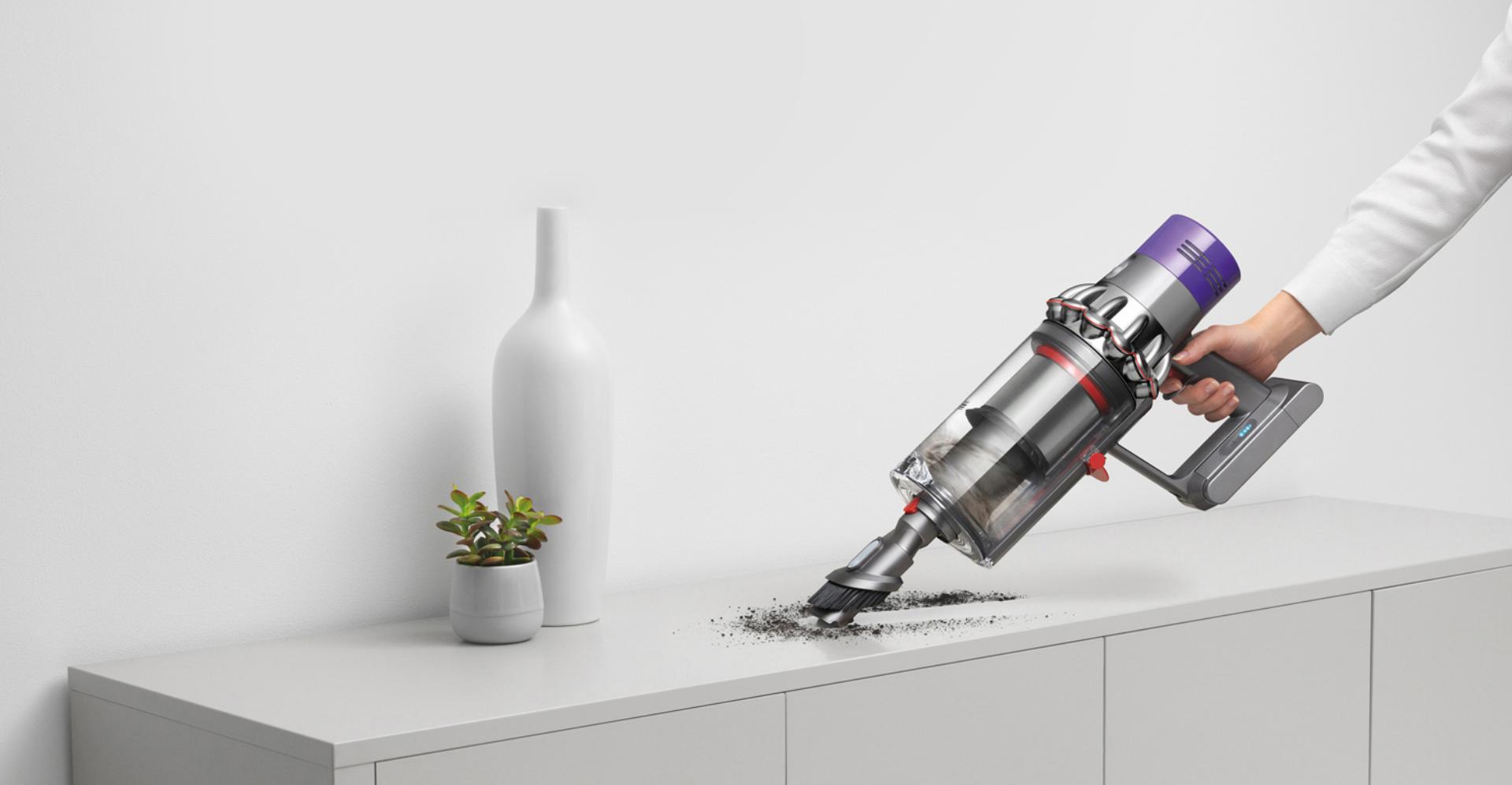 Dyson Cyclone V10 vacuum in handheld mode cleaning a hard surface.