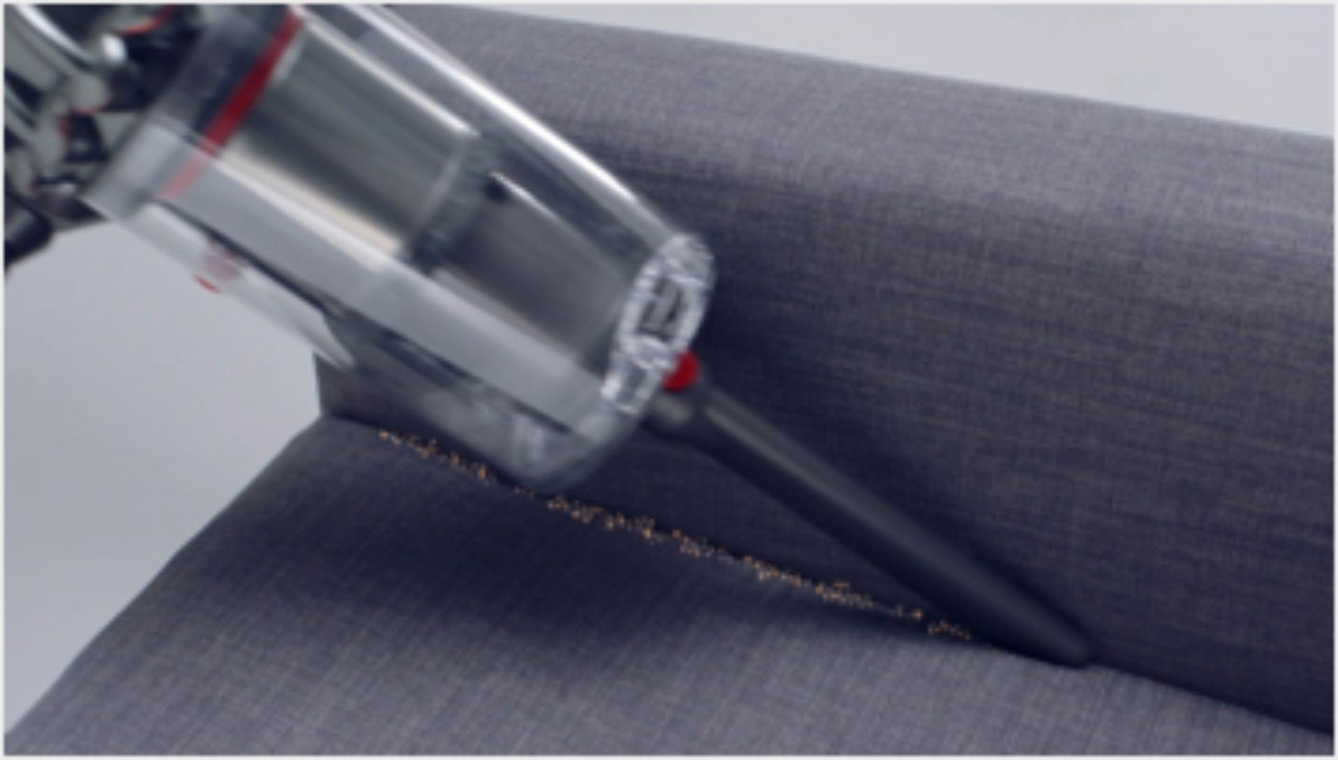 Dyson V11™ Crevice tool cleaning crevices of a sofa 