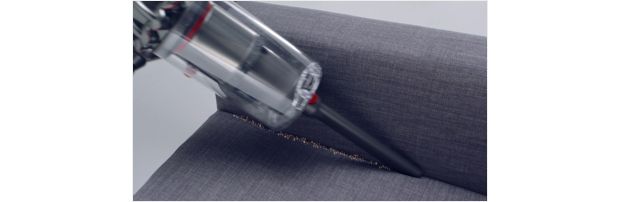 Dyson V11™ Crevice tool cleaning crevices of a sofa 