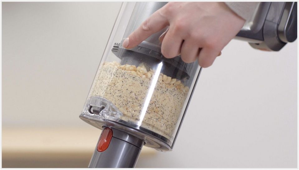 Dyson Laser Slim Fluffy cleaner head's laser showing dust particles on the floor