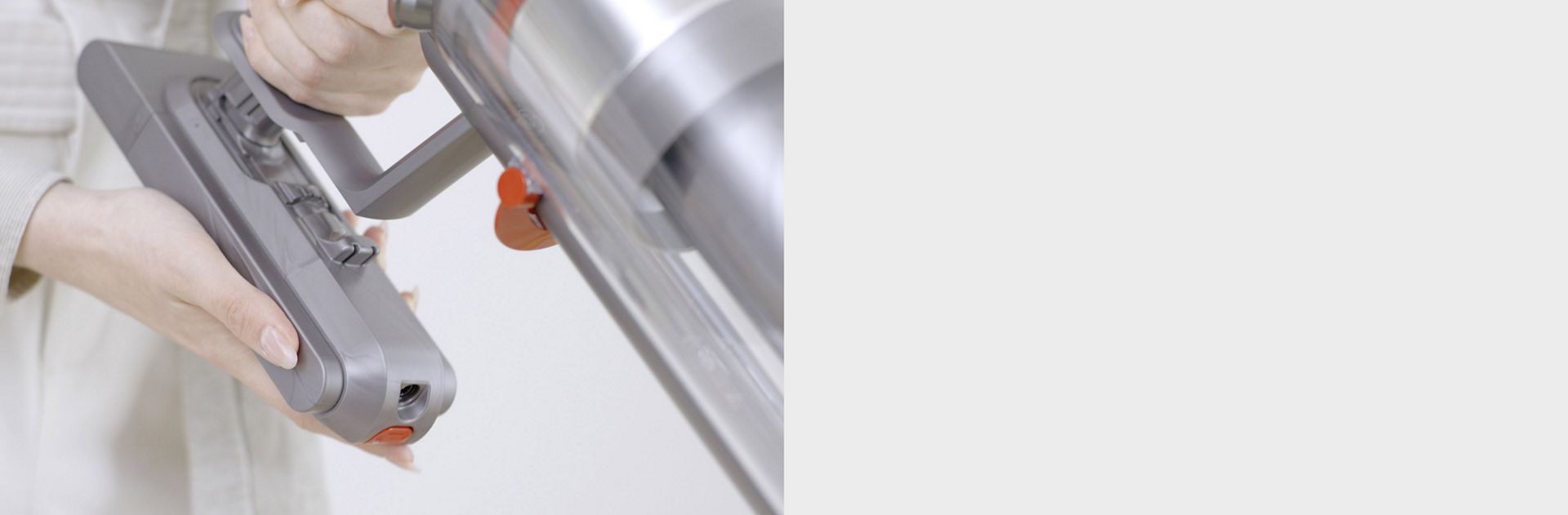 The user attaching a replacement Dyson battery.