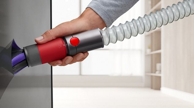 Extension hose being used to reach down low in a kitchen.