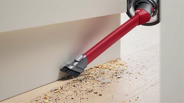 Awkward gap tool cleaning the space between a floor and a wall.