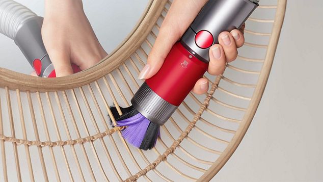 Scratch-free dusting brush cleaning a delicate mirror frame.