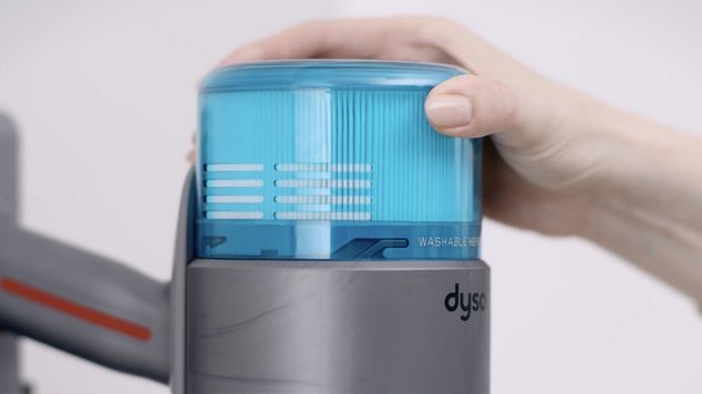 User twisting the filter counter clockwise to remove it from the body.