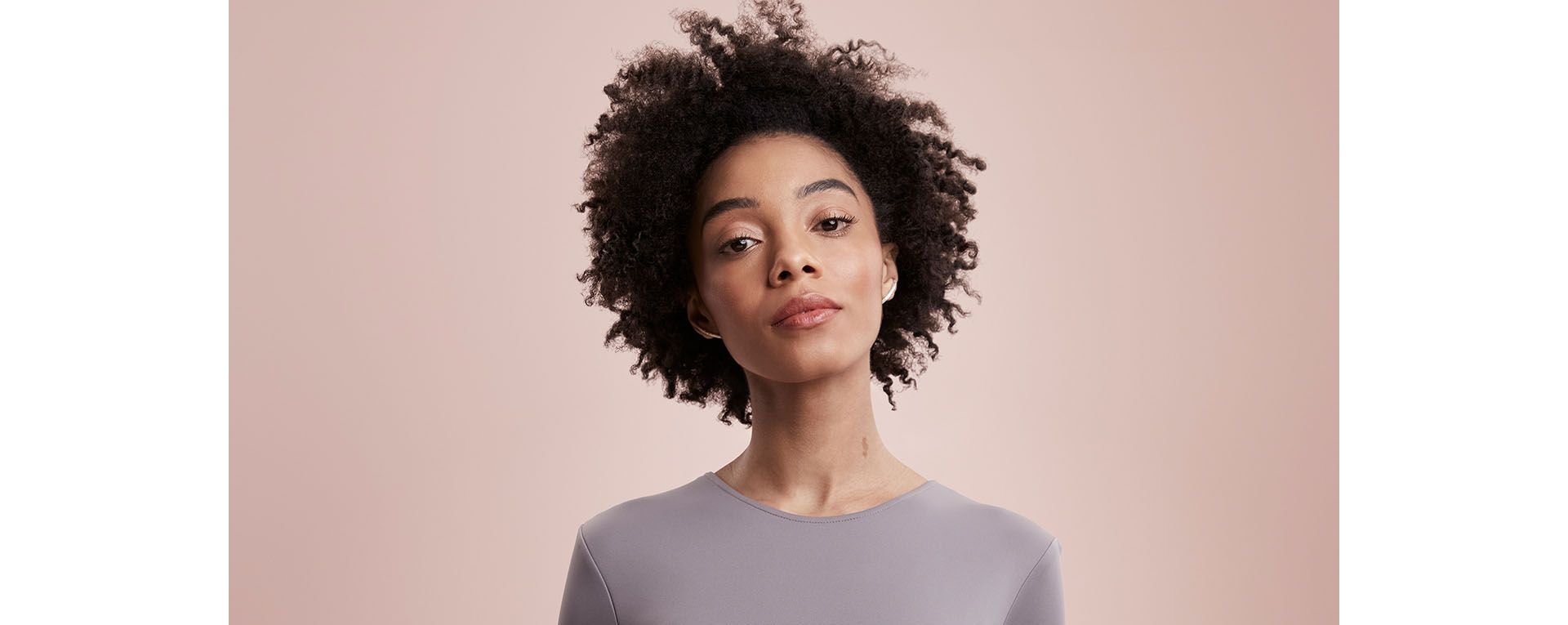 Model with curly, textured hair.