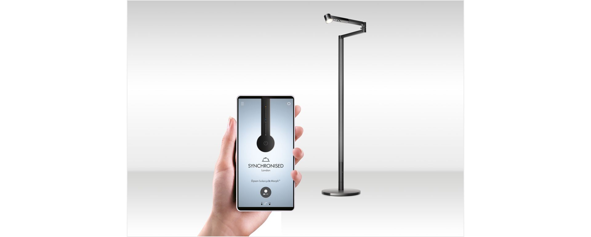Mano che regge un cellulare con aperta l’app Dyson Link per la lampada da lavoro Dyson Solarcycle Morph