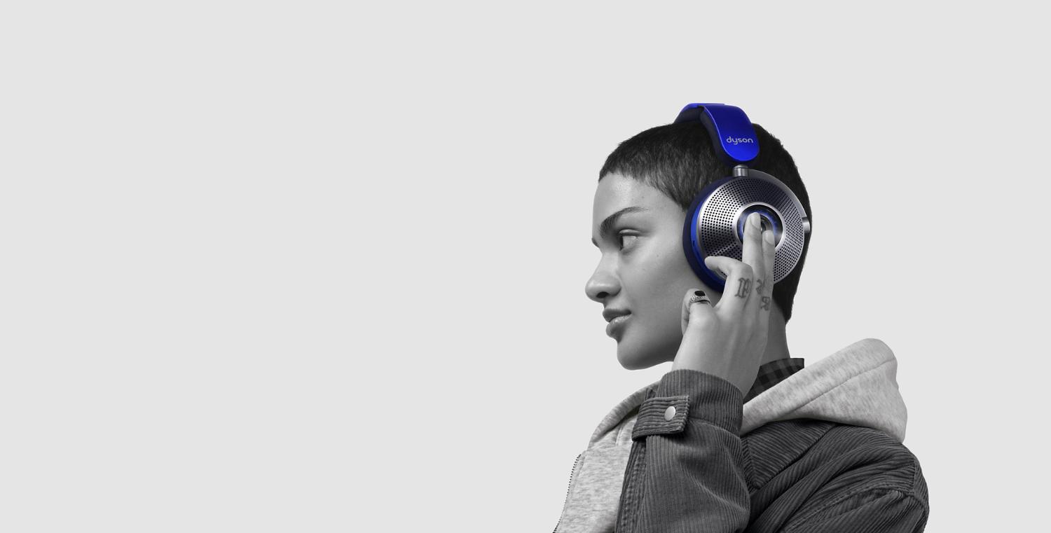 Woman taps the side of the ear cup to change ANC mode.