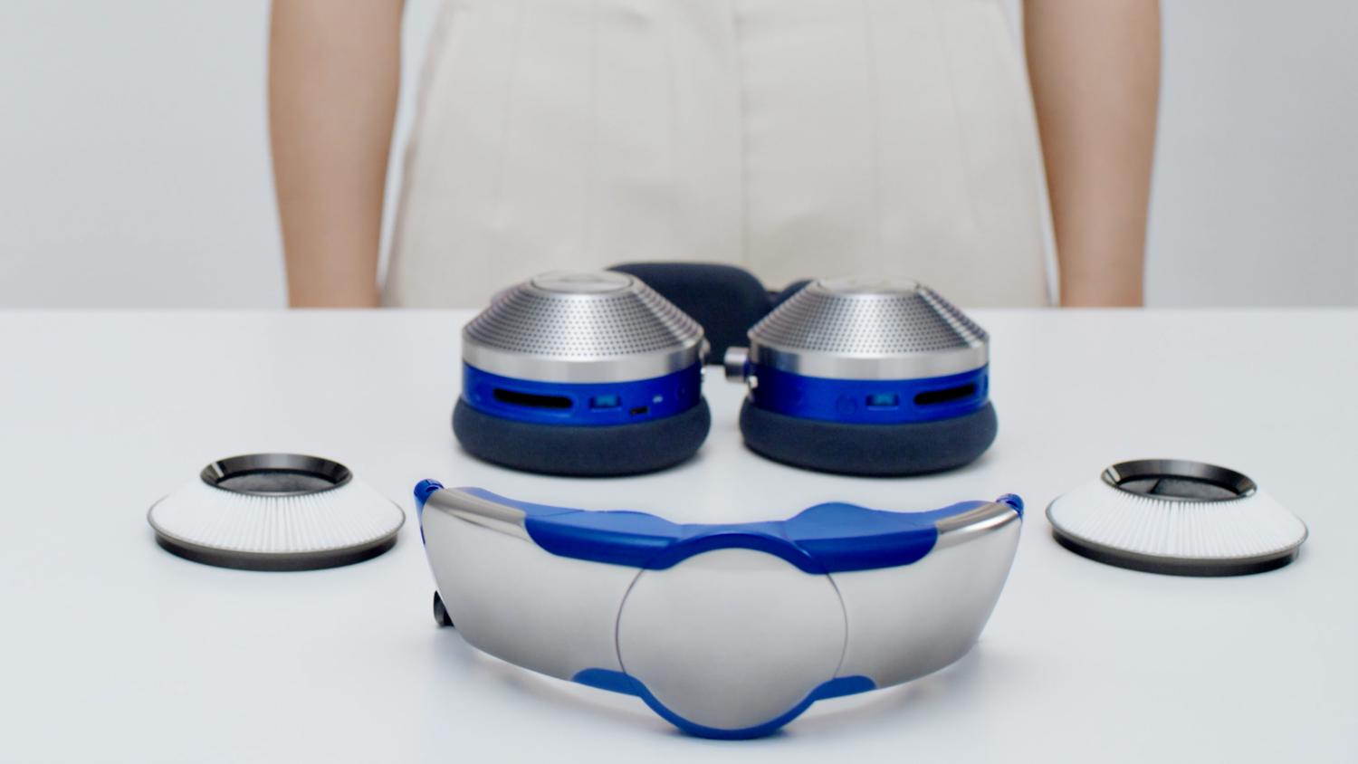 All the parts of the Dyson Zone headphones on a table top, ready to set up and connect.