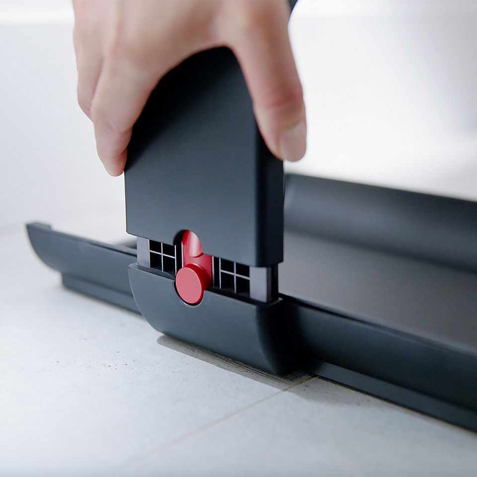 A user's hands assembling the docking station