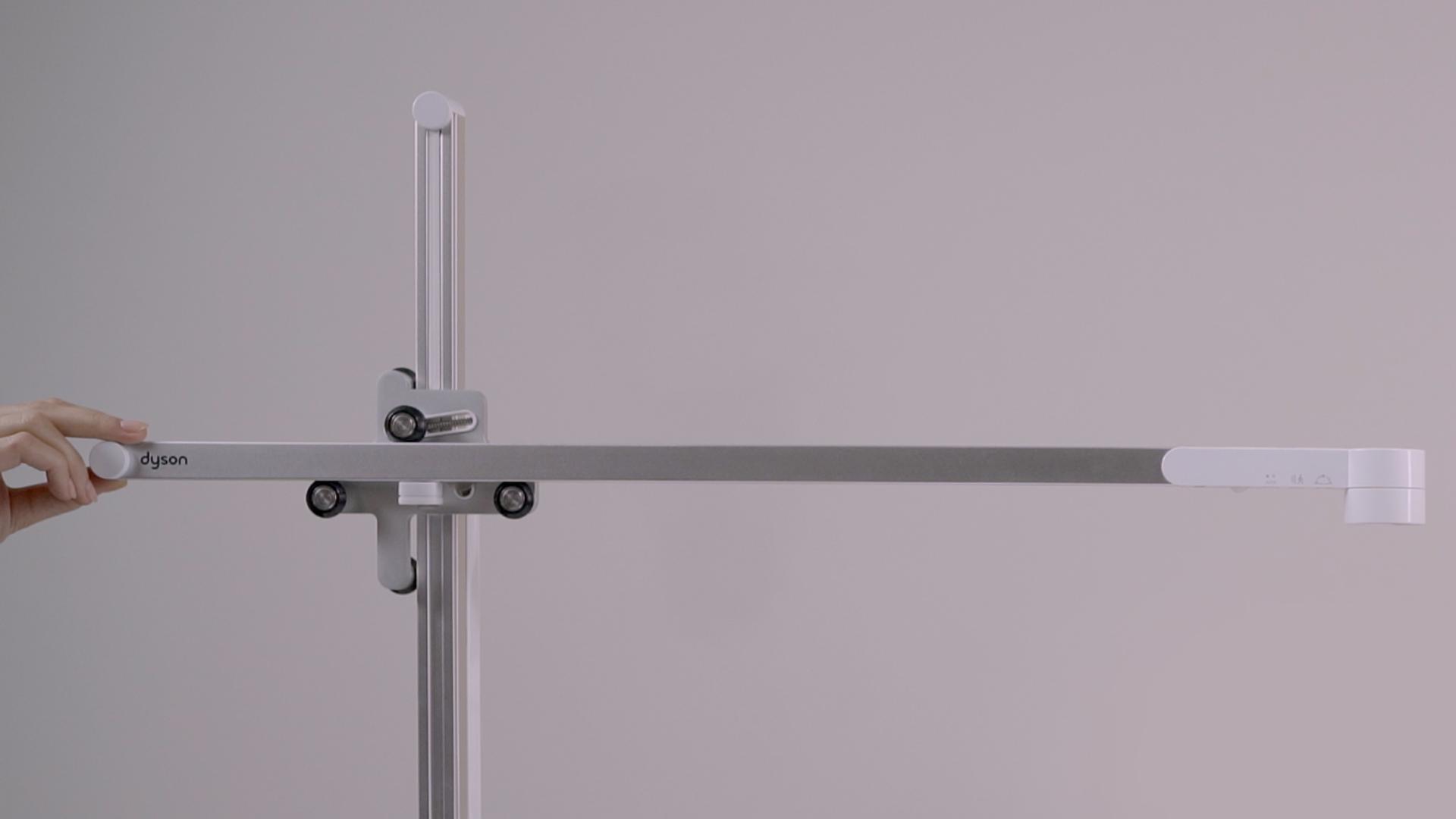 Hand positioning the light's arm