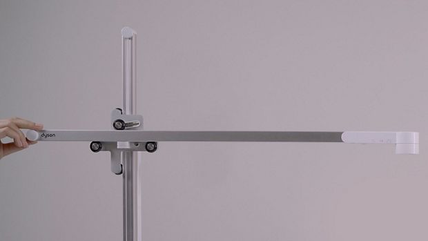 Hand positioning the light's arm