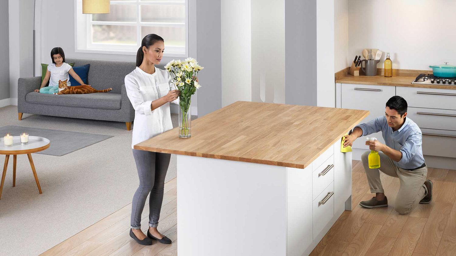 Femme et enfant dans une pièce avec des fleurs, le père nettoie