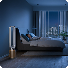 A person sleeps next to their Dyson Find+Follow Purifier Cool fan.