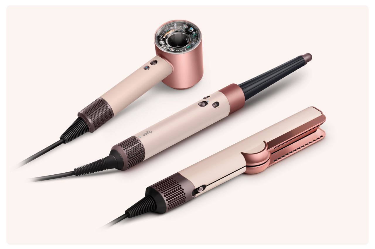 A collection of devices from the Dyson Beauty range in Ceramic pink and rose gold.