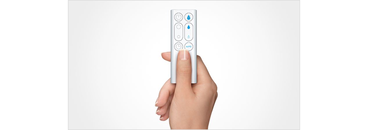 Remote control being held in a hand