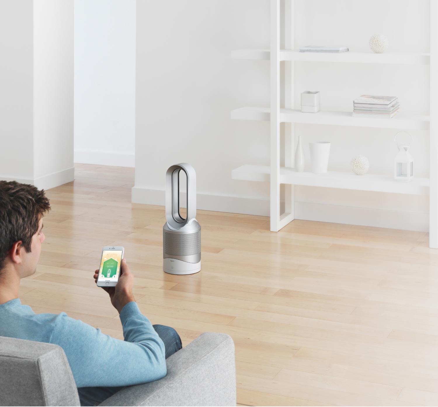 Man with smartphone and Dyson purifier