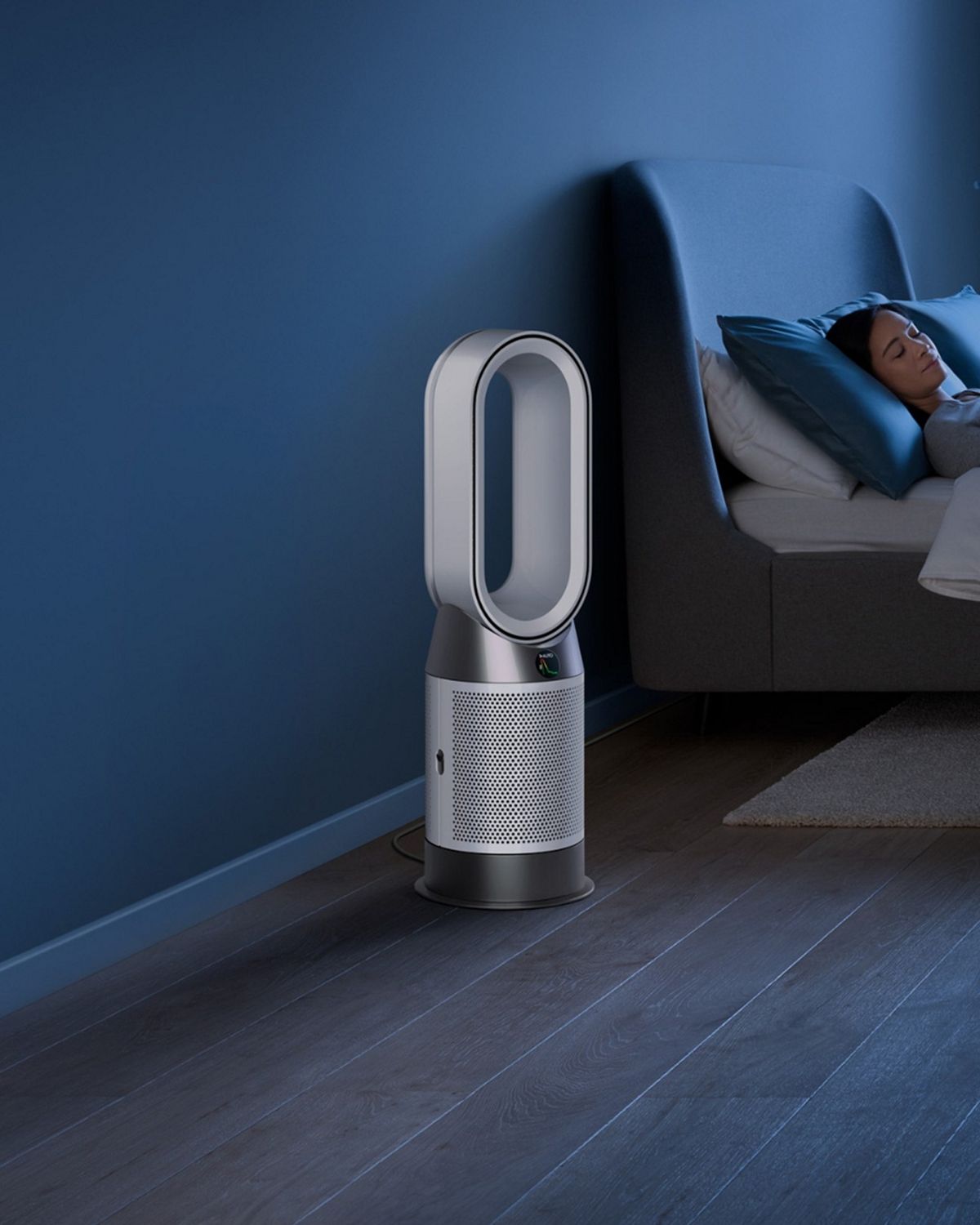 The Dyson Purifier Hot+Cool HP1 heating purifier operating in Night mode next to a sleeping person.