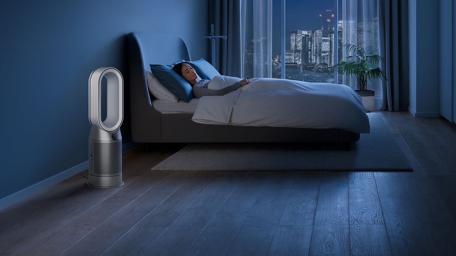 The Dyson Purifier Hot+Cool HP1 heating purifier operating in Night mode next to a sleeping person.