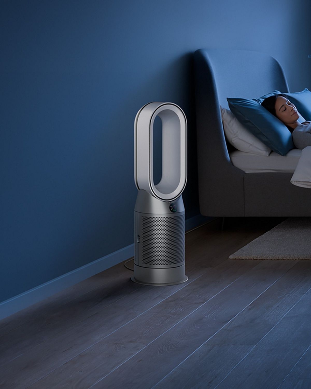 The Dyson Purifier Hot+Cool HP1 heating purifier operating in Night mode next to a sleeping person.