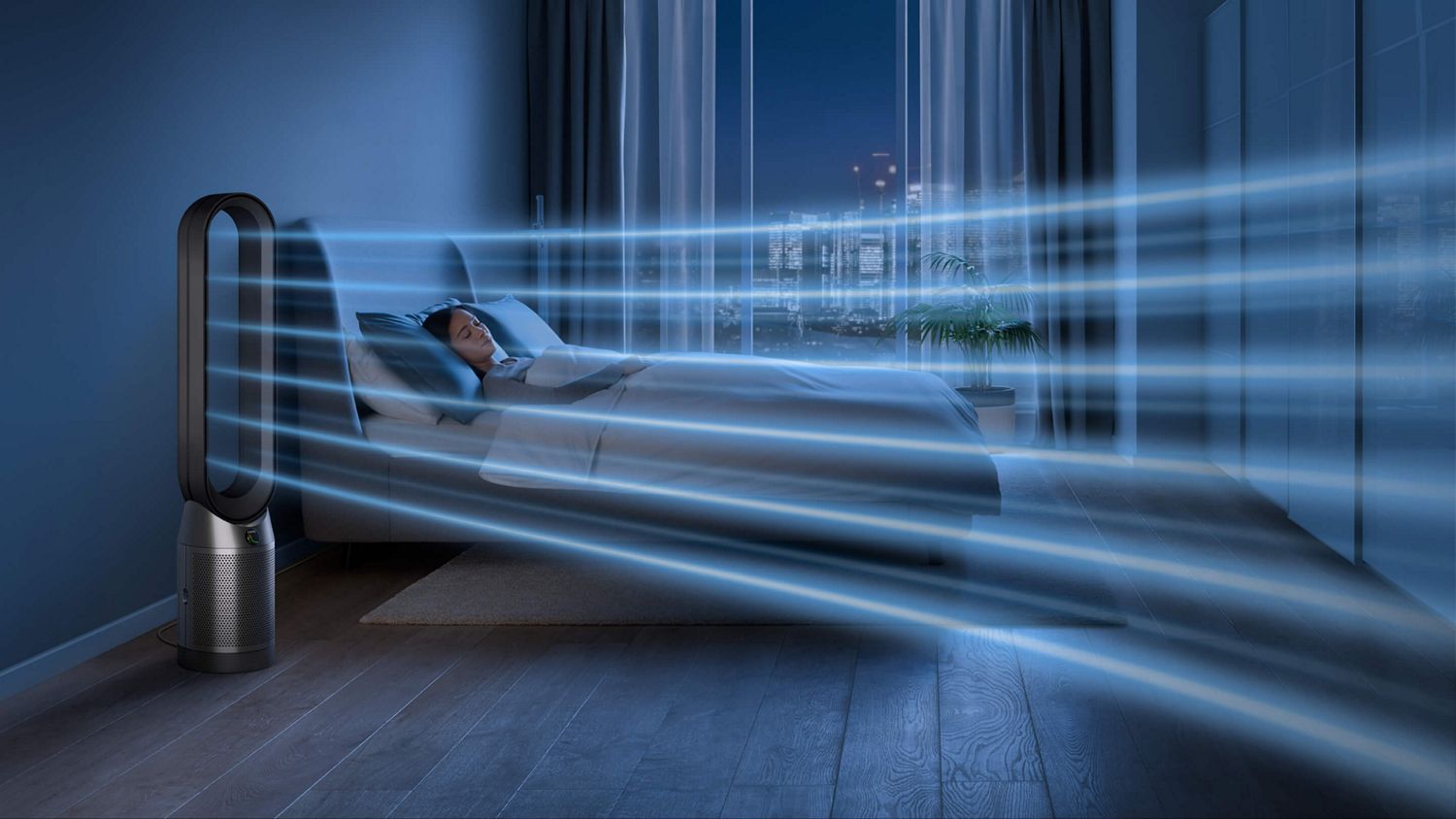 The Dyson Purifier Cool PC1 air purifier operating in Night mode next to a sleeping person.