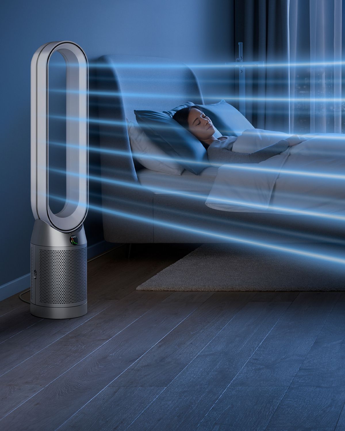 The Dyson Purifier Cool PC1 air purifier operating in Night mode next to a sleeping person.