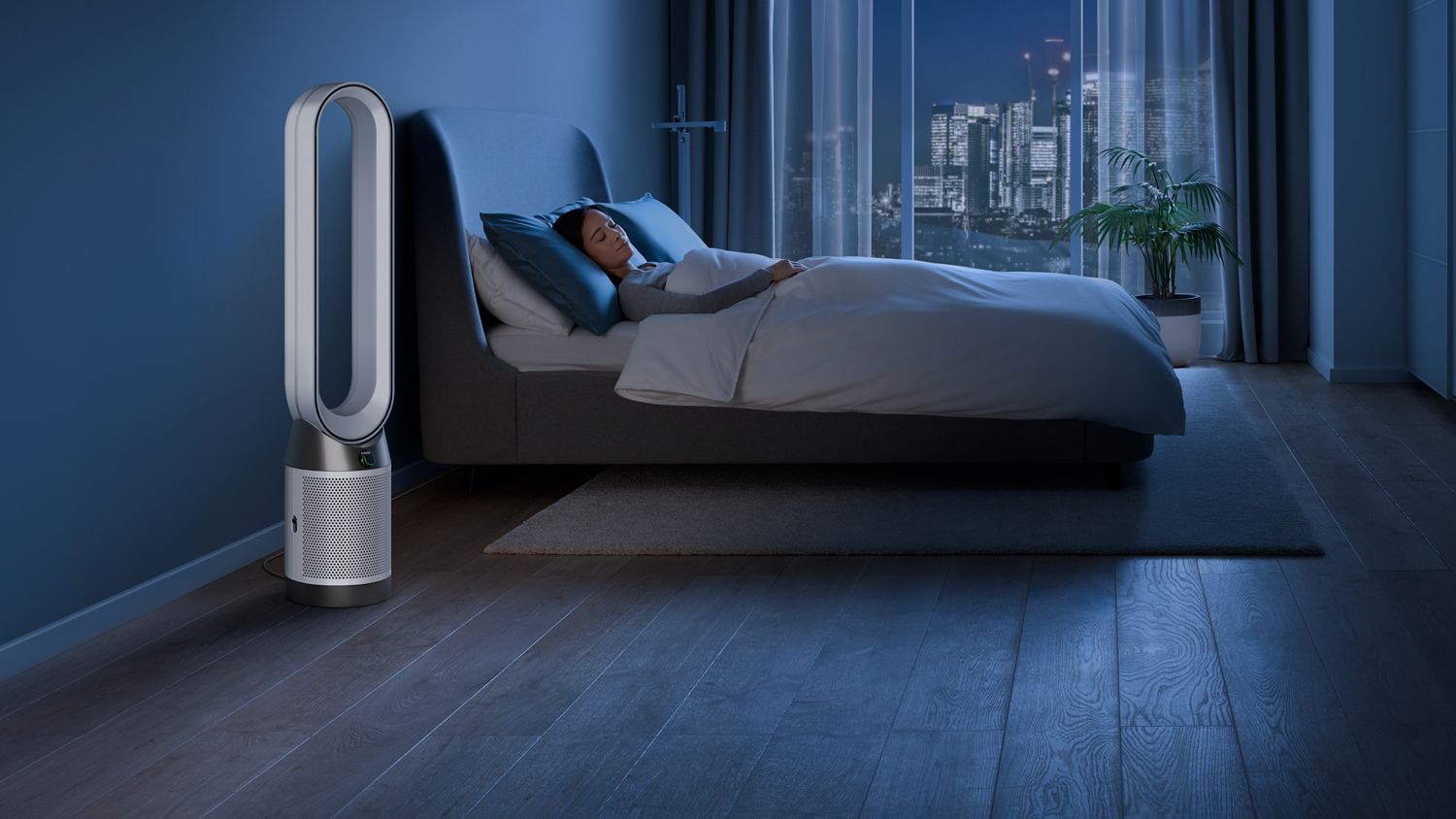 Purificateur Dyson Cool PC1 fonctionnant en mode nocturne près d’une personne endormie.