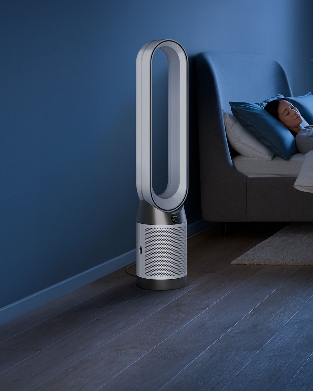 The Dyson Purifier Cool PC1 air purifier operating in Night mode next to a sleeping person.