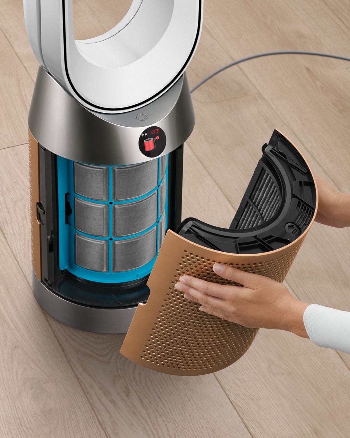 Person removing the purifier shrouds to change the filter.