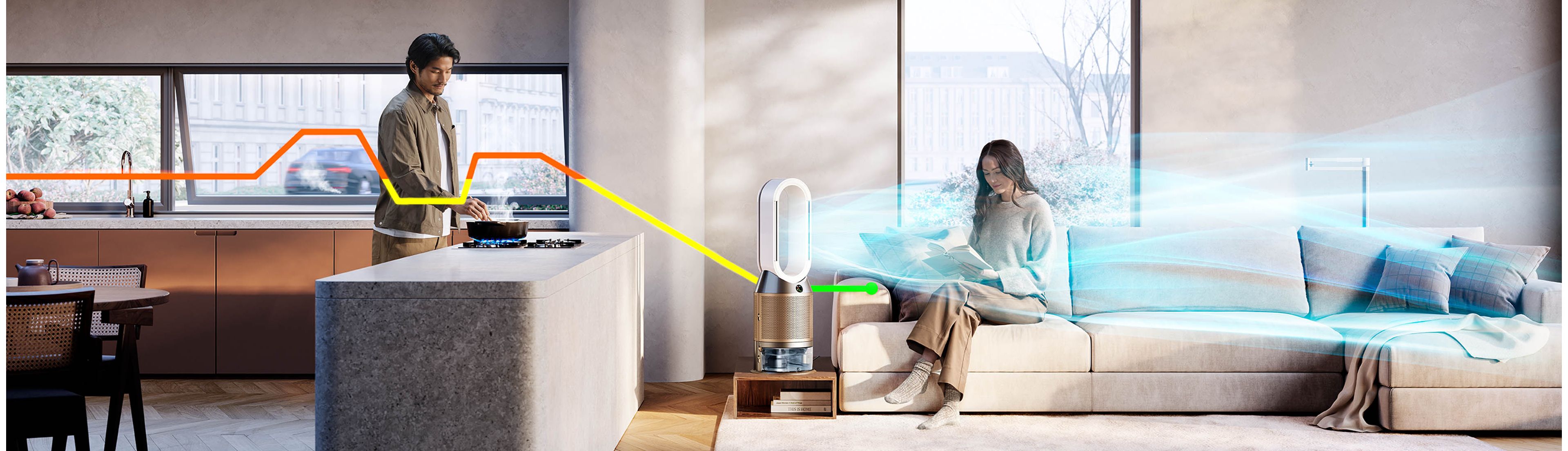 A living area with one person cooking and another sitting on the sofa reading. A Dyson air purifier with humidification function cleans the air.