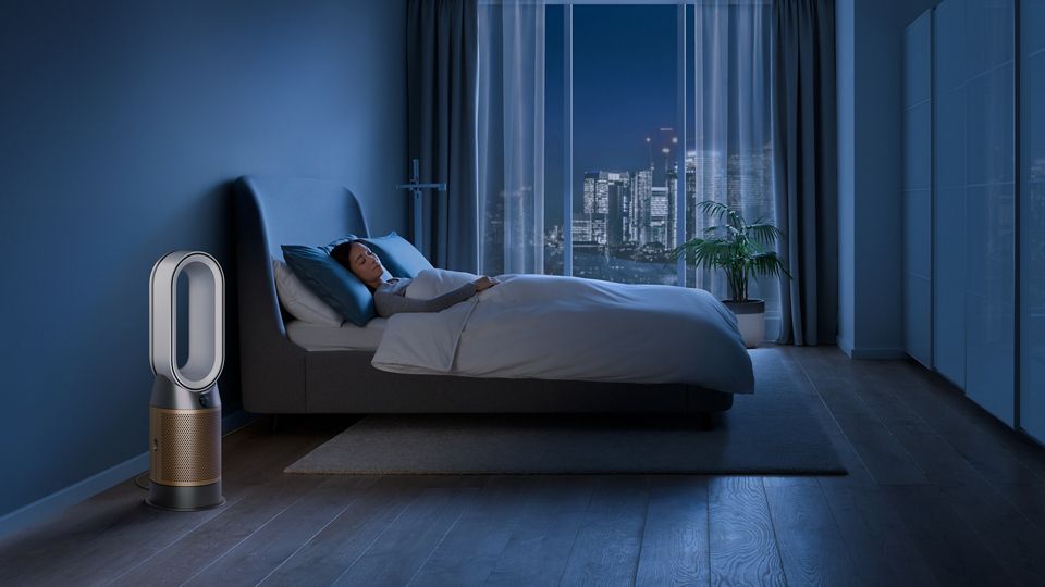  Woman in bed beside Dyson Purifier fan
