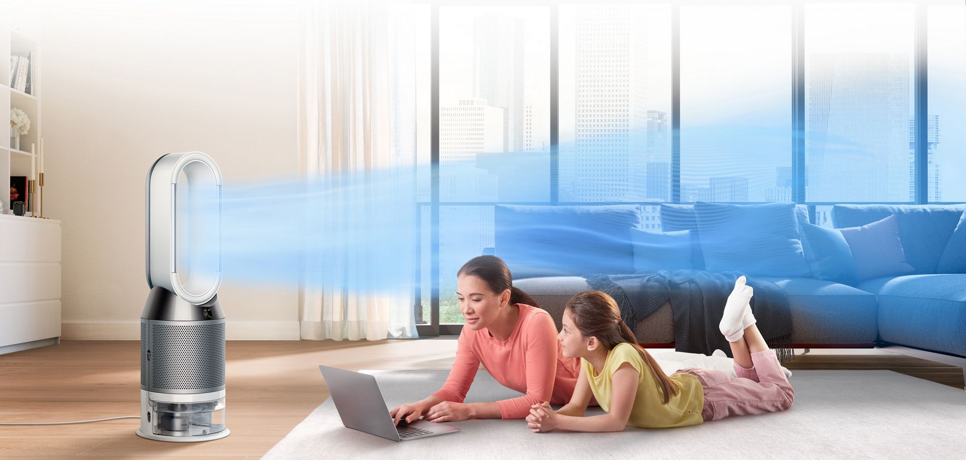 A mother and daughter being cooled by the Dyson purifier humidifier fan on a hot day