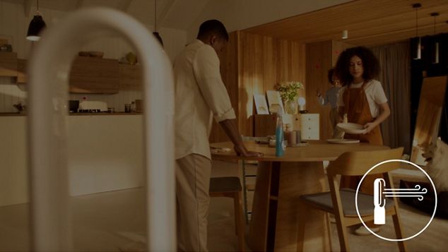 A family cleaning their kitchen table before dinner.