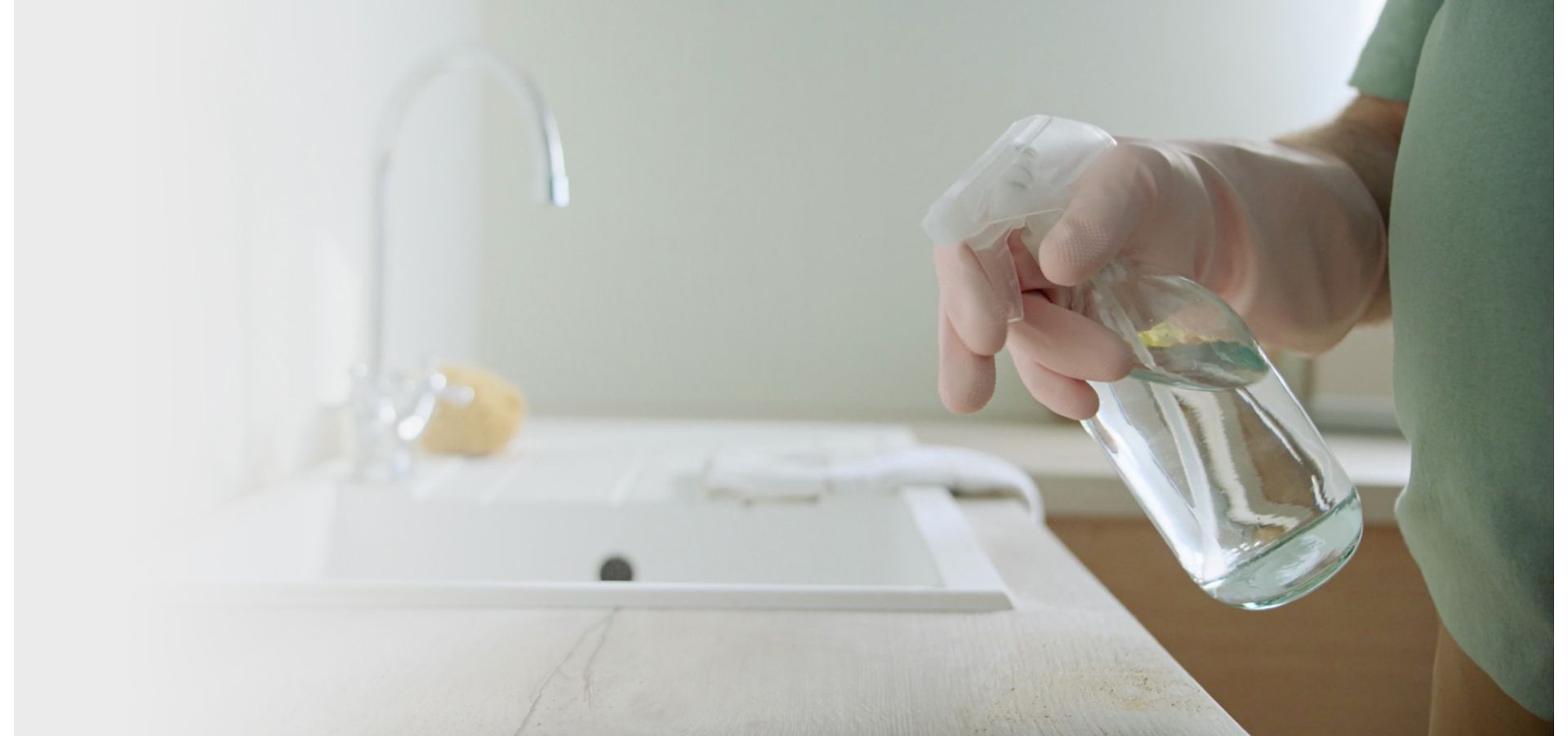 A person using a cleaning product on a surface.