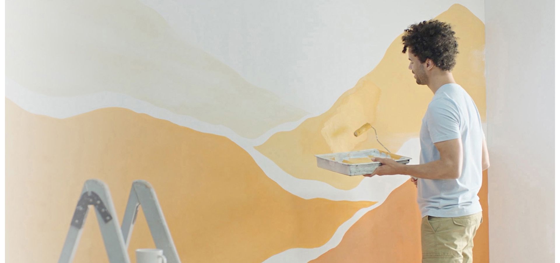 A man painting a wall.