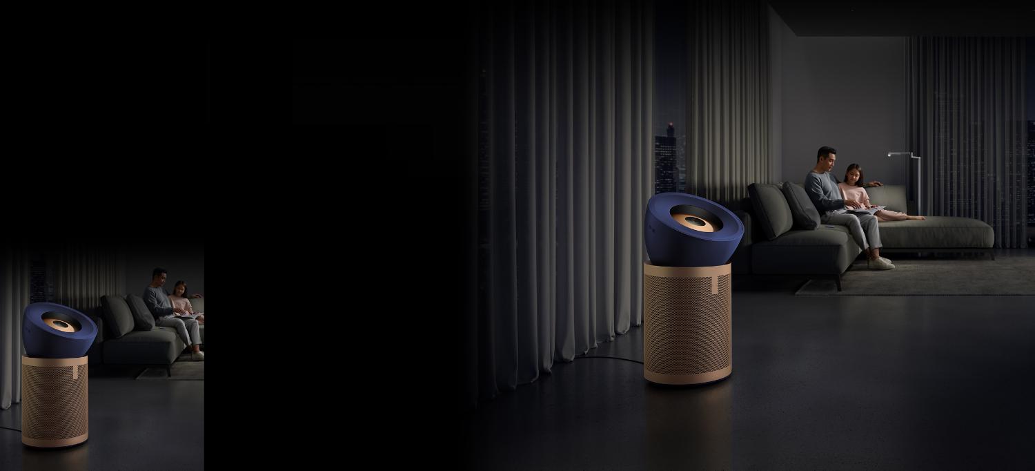 Dyson Purifier Big+Quiet Formaldehyde in a living room next to a sofa where a father and daughter are reading.