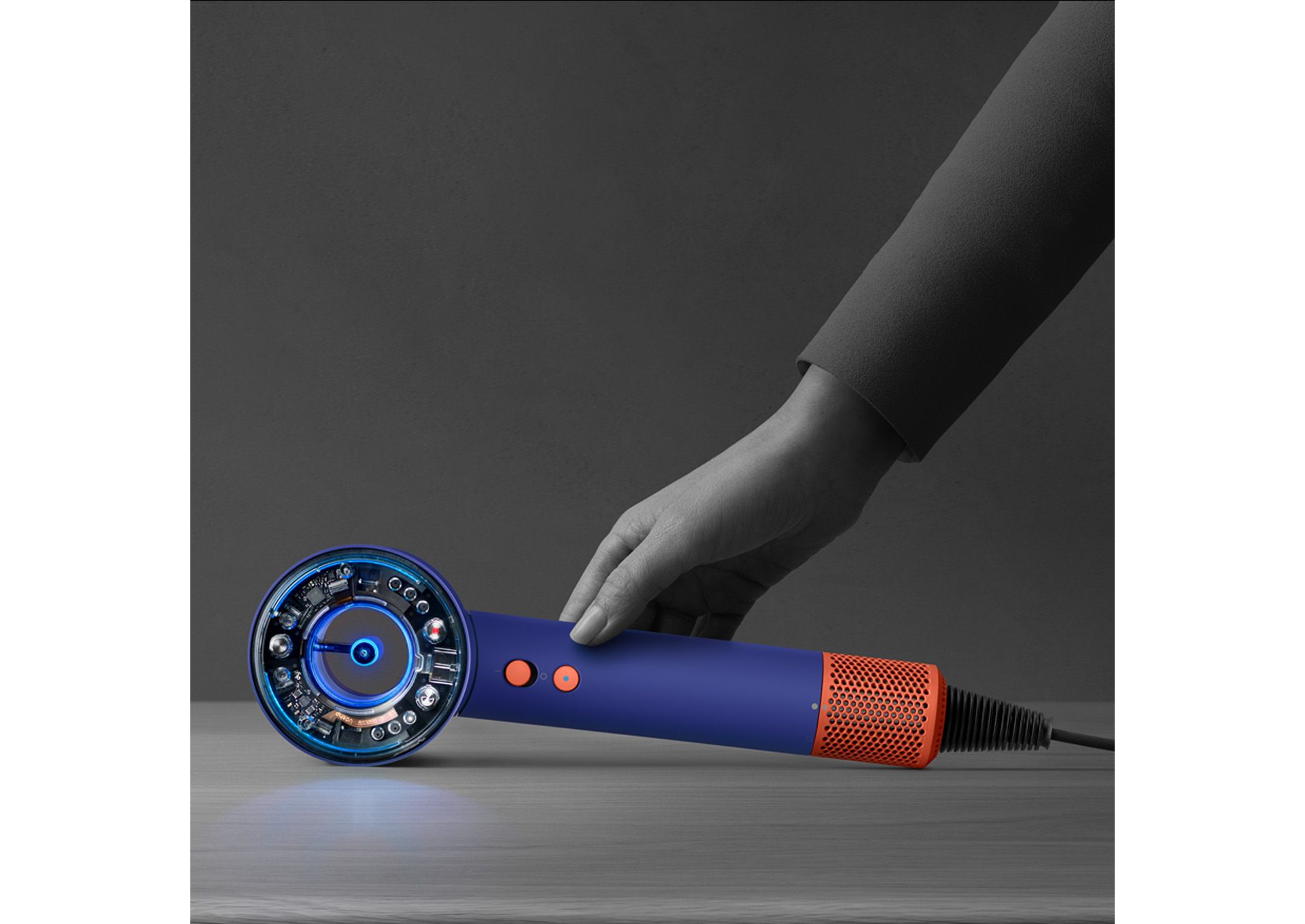The Dyson Supersonic Nural hair dryer is rested on a table, activating the Pause detect mode.