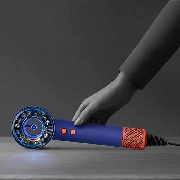 The Dyson Supersonic Nural hair dryer is rested on a table, activating the Pause detect mode.