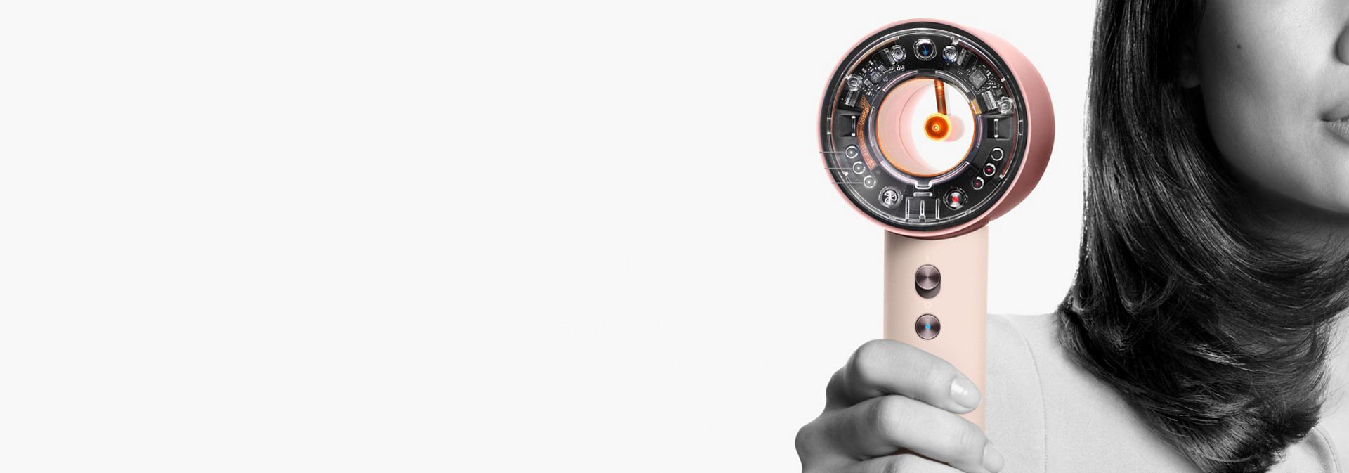 The Dyson Supersonic nural held by a model.