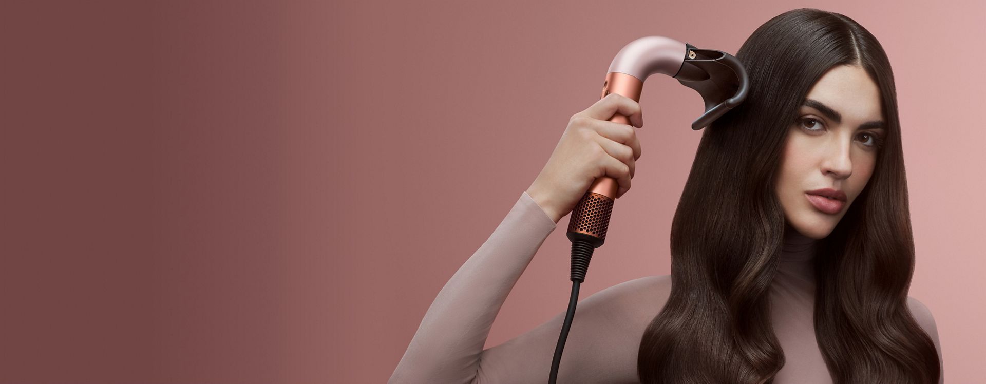 Dyson Supersonic r hair dryer used by a model to dry her hair.