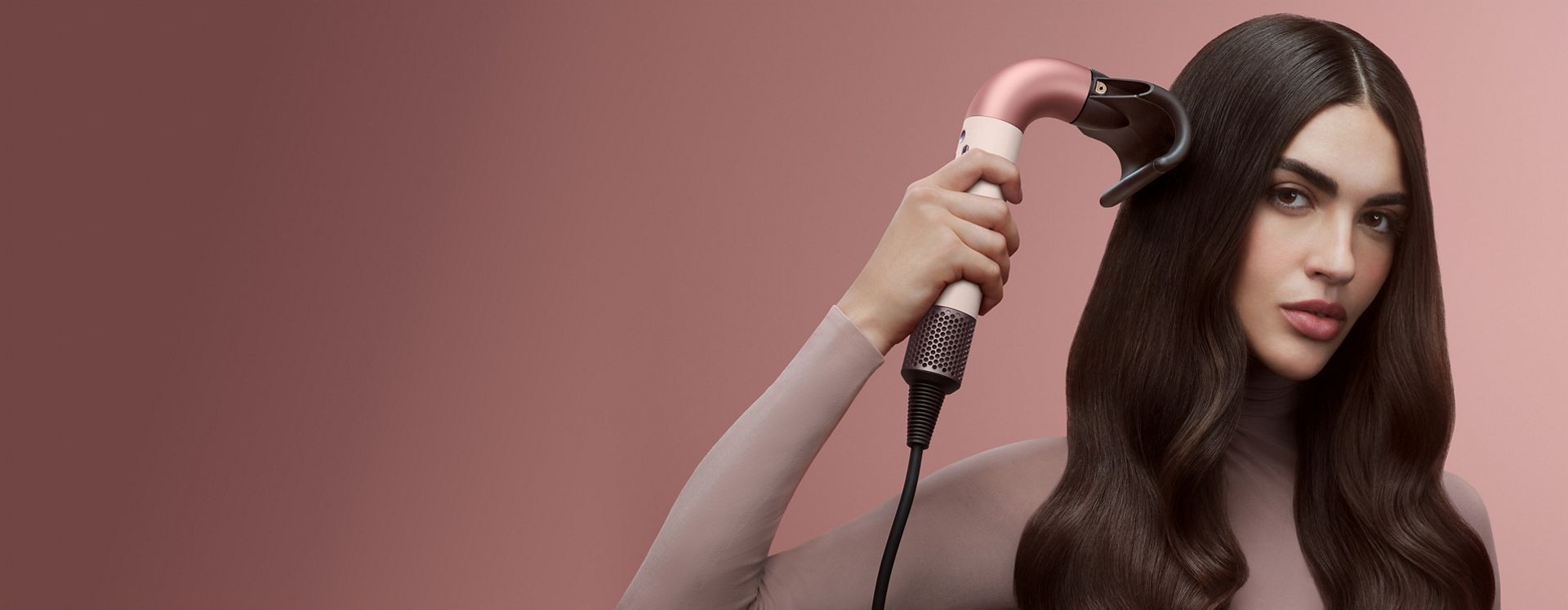 Dyson Supersonic r hair dryer used by a model to dry her hair.