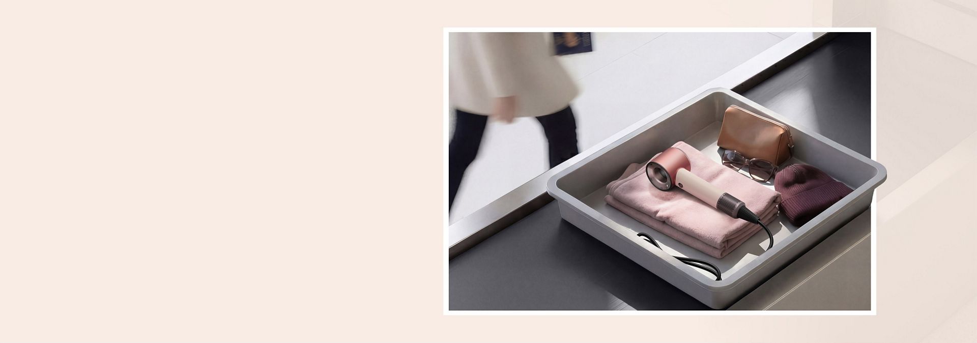 Dyson Supersonic Travel hair dryer in an Airport luggage screening tray.