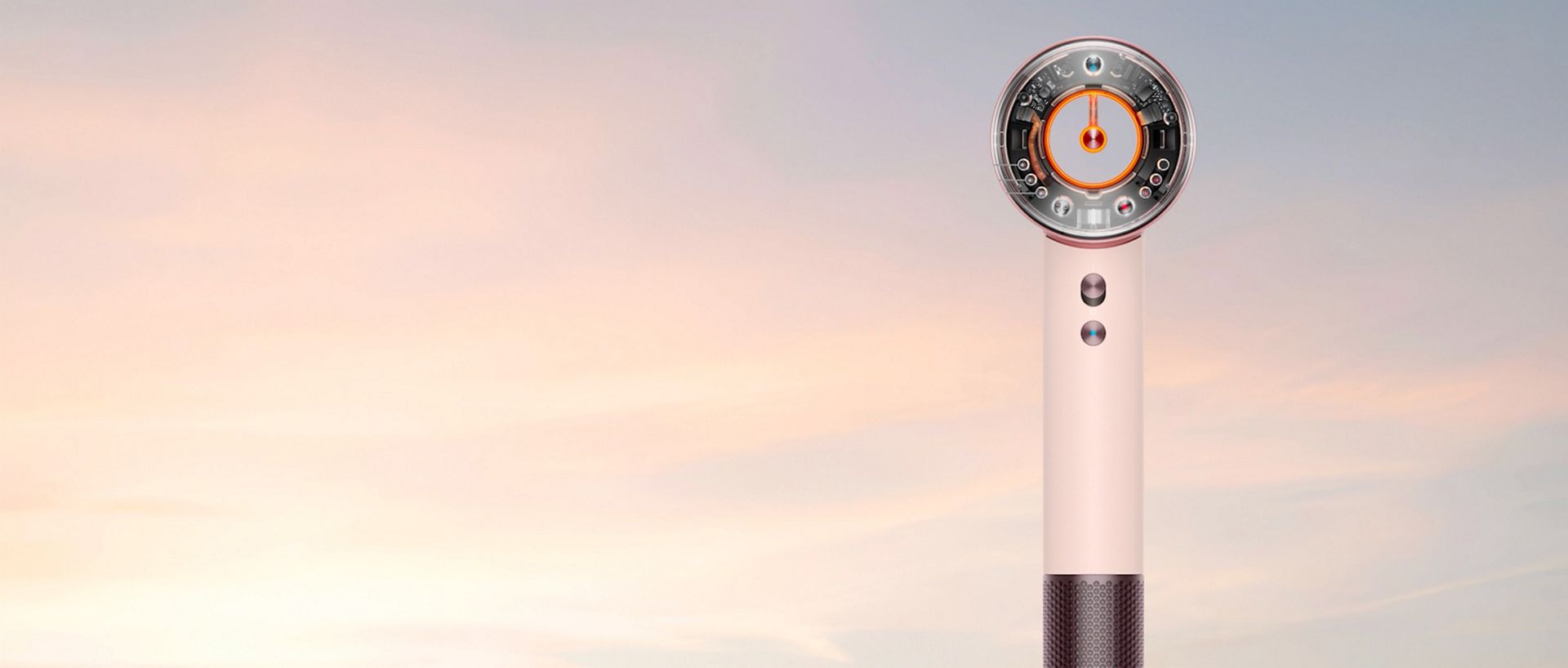 Dyson Supersonic Travel hair dryer in front of a sunrise.