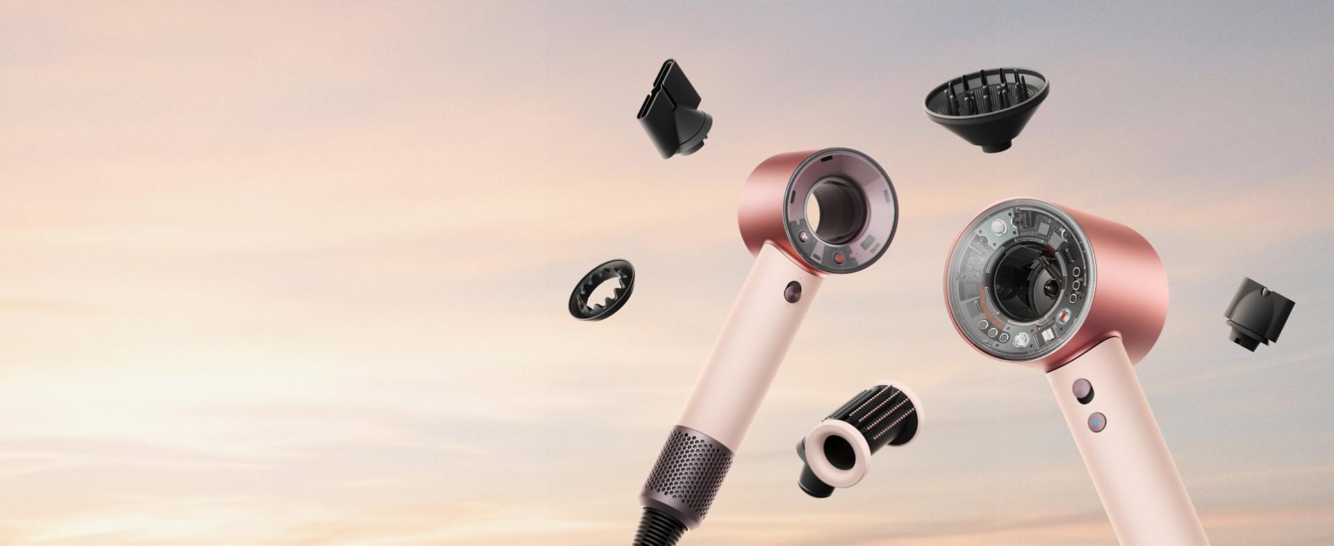 Dyson Supersonic Nural and Travel hair dryers surrounded by attachments.